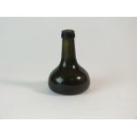 Small dark green glass bottle