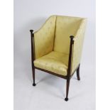 An Arts and Crafts mahogany satin wood banded and ebony strung enclosed armchair