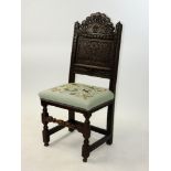 A carved oak backstool 17th century