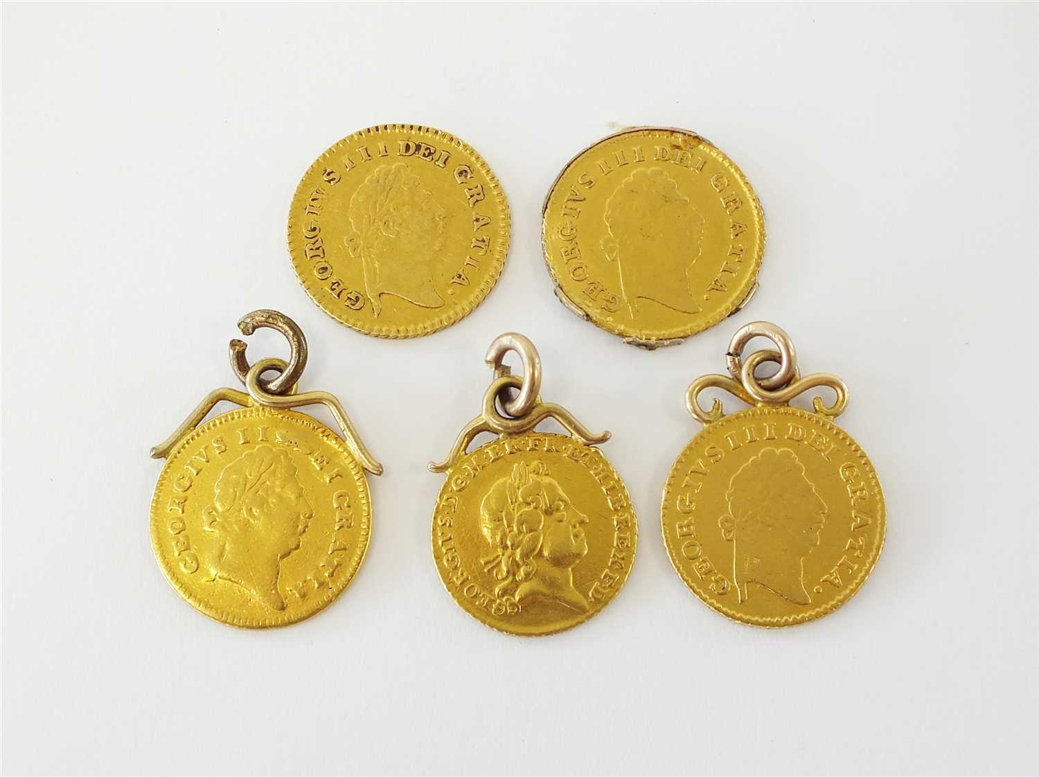 A collection of five gold British coins