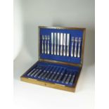 A cased set of twelve silver knives and forks