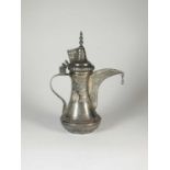An Islamic white metal coffee pot