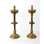 A pair of Victorian brass Gothic revival candlesticks