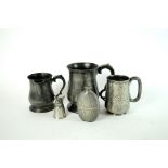 A collection of pewter drinking vessels and measures etc