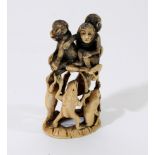 A Japanese carved ivory okimono of a toad and monkey group