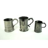 A collection of twelve 18th and 19th century pewter mugs and measures