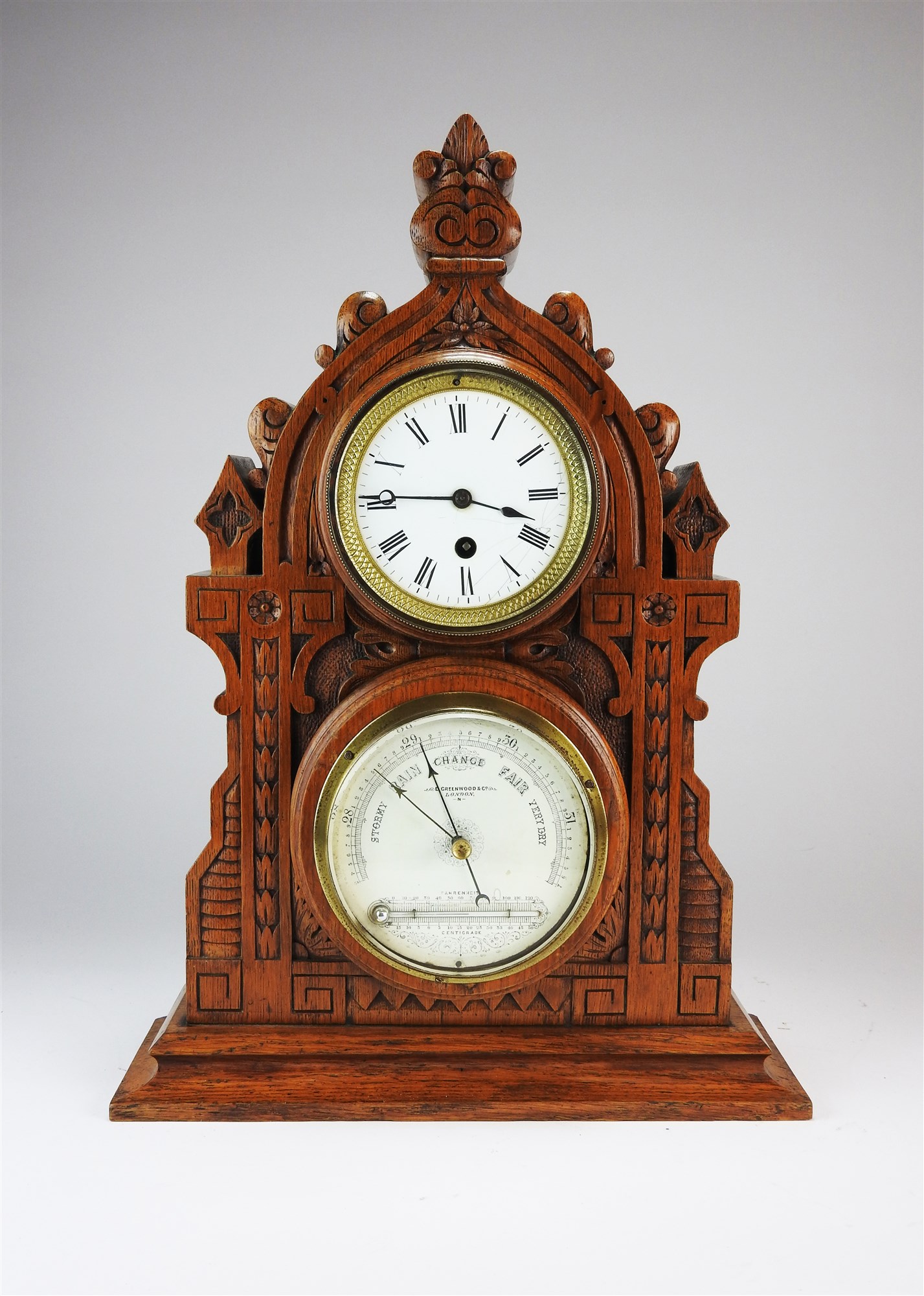 A Victorian gothic oak cased combined mantel timepiece and barometer