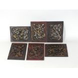 A set of six Chinese carved and pierced red lacquer and gilt panels