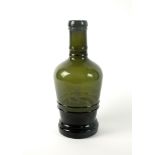 A large green glass Naval bottle