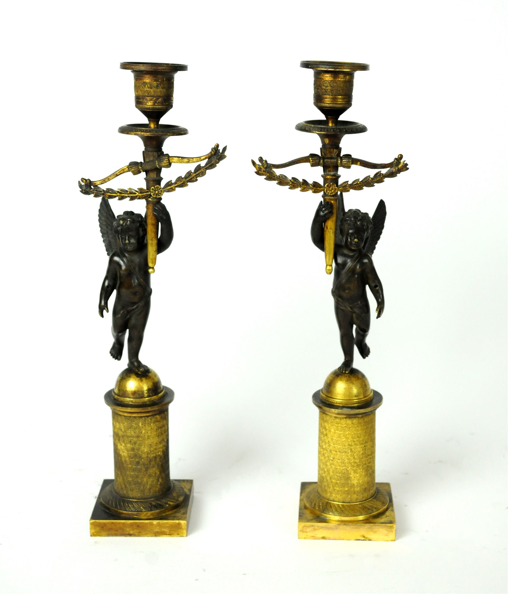 A pair of early 19th century Empire bronze and gilt candlesticks