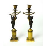 A pair of early 19th century Empire bronze and gilt candlesticks