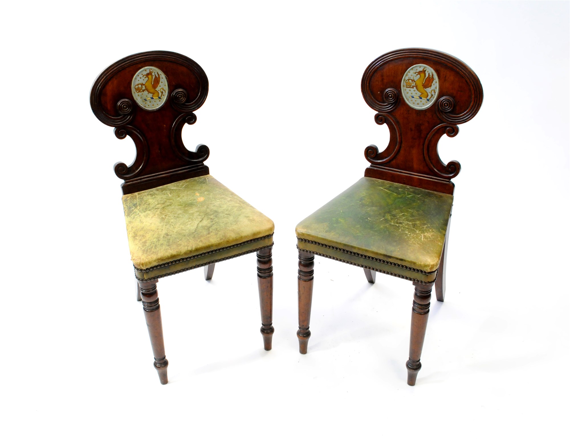 A pair of Regency mahogany hall chairs, in the manner of Gillows