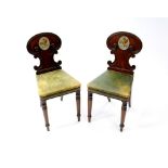 A pair of Regency mahogany hall chairs, in the manner of Gillows
