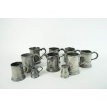 A large collection of 22 pewter drinking vessels, mugs, measures etc