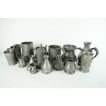 A collection of pewter drinking vessels and measures