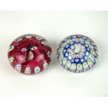 Two Arculus glass paperweights
