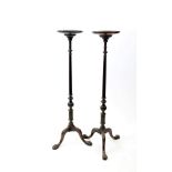 A pair of George III style mahogany torchere stands