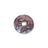 A Chinese dark green and russet jade 'chilong' disc, Bi, possibly Warring States (475-221 BC)