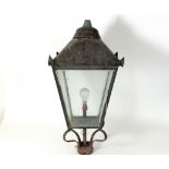 A copper and wrought iron gatepost lantern