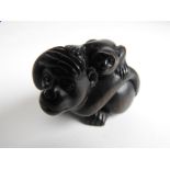 A Japanese rosewood netsuke of a monkey