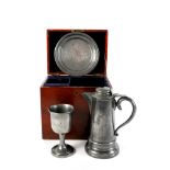 A cased three-piece pewter communion set