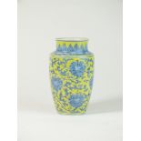 A Chinese porcelain lemon yellow and blue and white vase