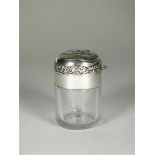 A silver topped glass jar