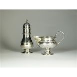 A silver cream jug and sugar caster