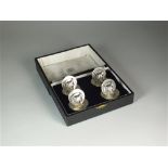 A cased set of four silver menu holders