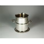 A tall silver wine coaster