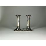 A pair of silver mounted candlesticks