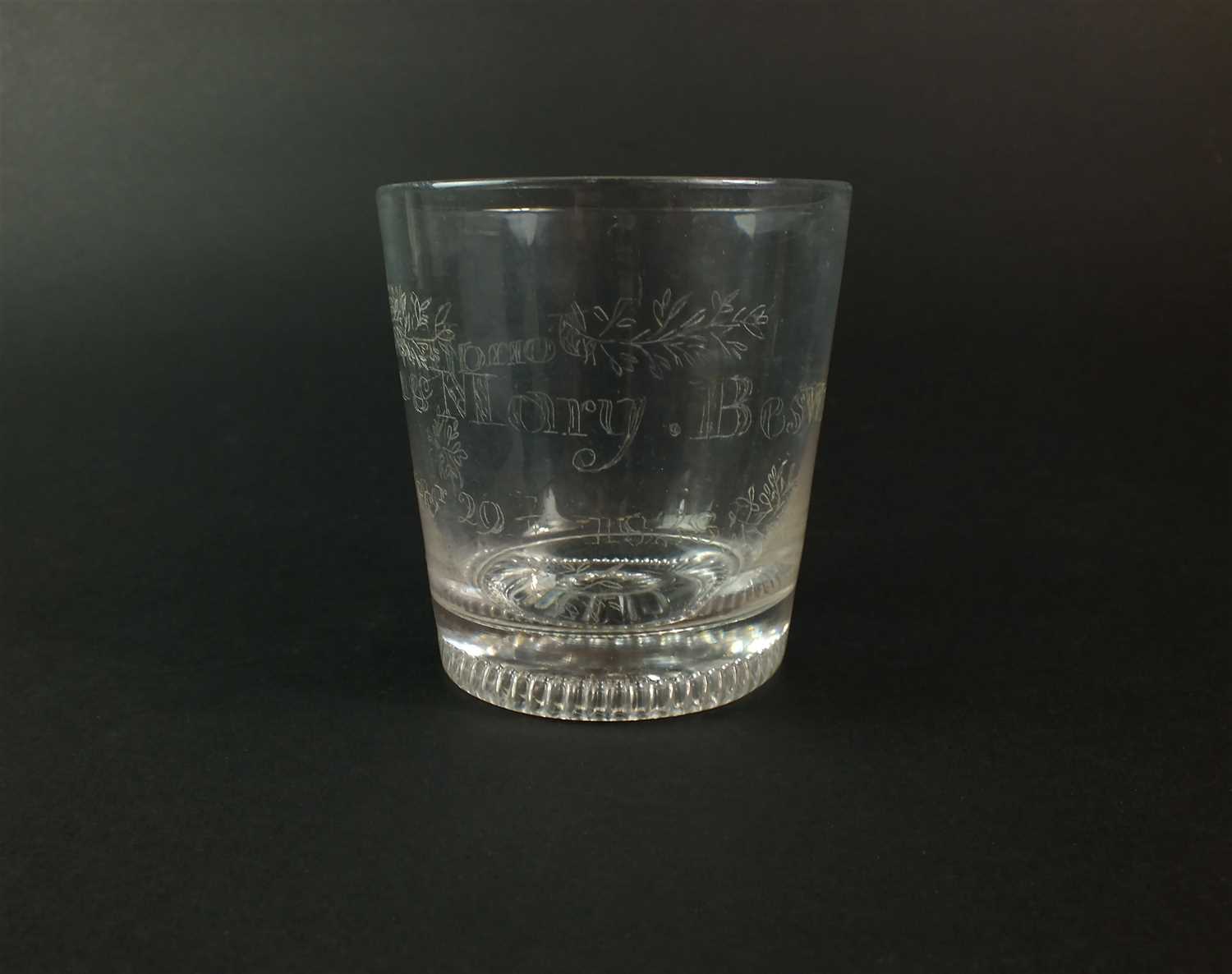 A commemorative glass tumbler