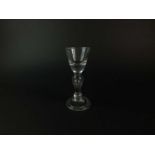 A heavy baluster wine or dram glass, circa 1710