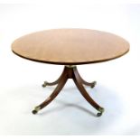 A large Edwardian cross-banded mahogany breakfast table