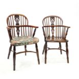 A closely associated set of four 18th century Windsor stick back kitchen chairs