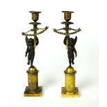 A pair of early 19th century Empire bronze and gilt candlesticks