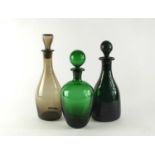Three glass decanters and stoppers