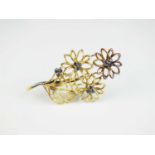 An 18ct gold sapphire set floral spray brooch