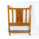 A pair of Art Nouveau carved pale oak single beds