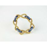An yellow metal and blue enamel stylised rope brooch