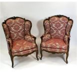 A pair of Louis XV style 19th century wing back armchairs