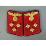 A matched set of German Third Reich Gau level collar tabs for an Einsatzleiter, constructed of red