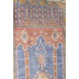 A Baluch Rug, West Afghanistan, The Indigo field with lamp, beneath the Mihrab, enclosed by leaf and