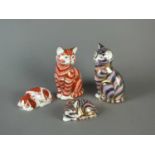 Four Royal Crown Derby paperweights of cats and a dog