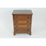 A reproduction rustic oak chest of four long drawers in the old English style