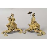 A pair of 19th continental century cast brass Rococo figural desk weights populated with stylised