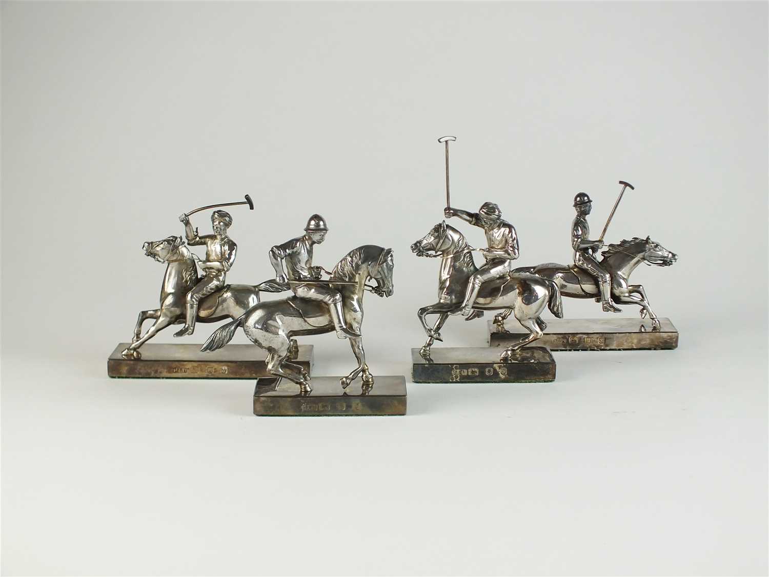 A set of four silver Polo match models