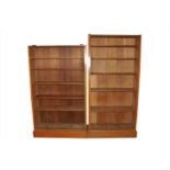 Two associated tall early 20th century pale oak bookcases