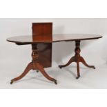 A twin pillar mahogany pedestal dining table