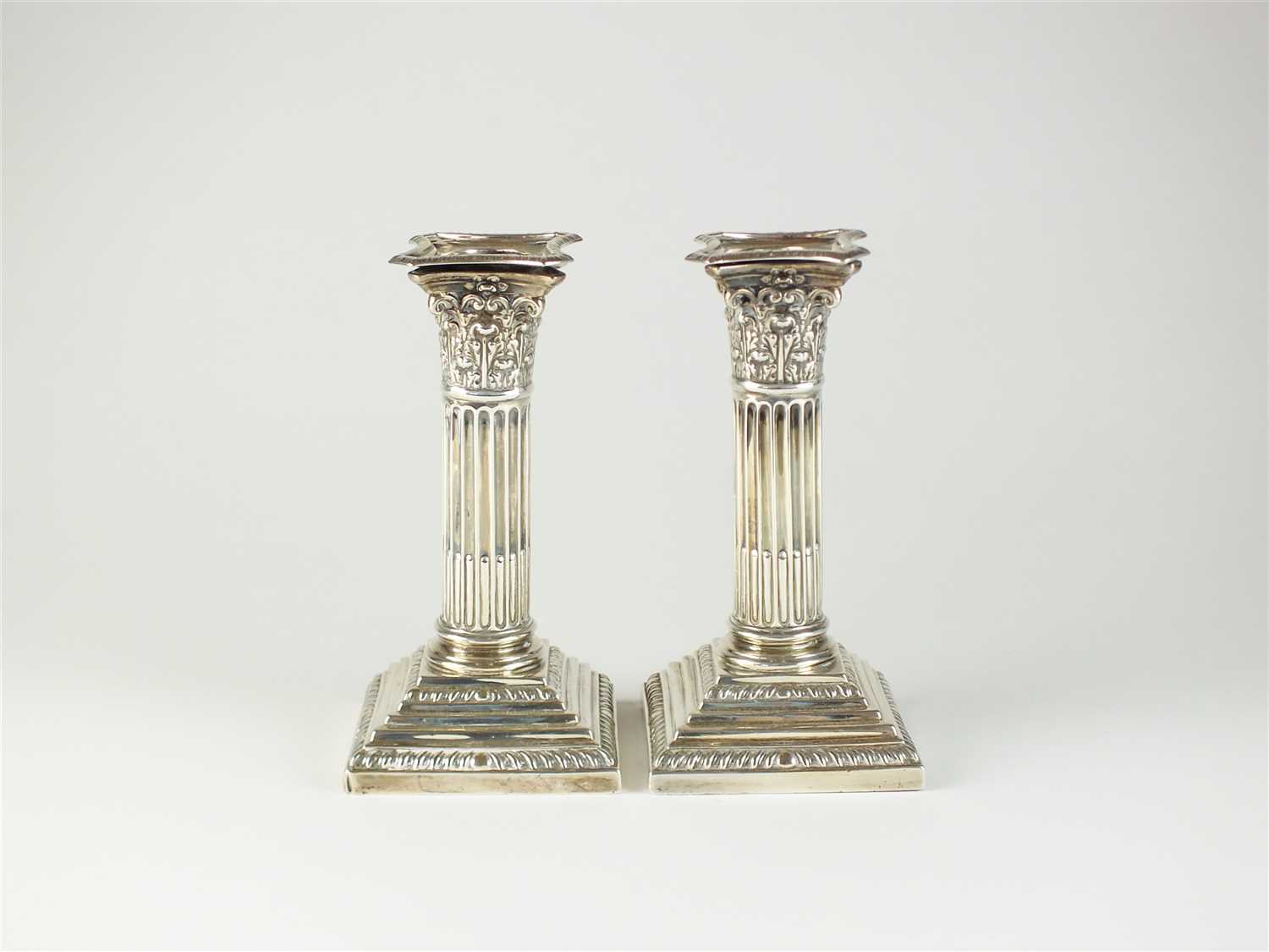 A pair of silver mounted candlesticks